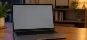 An open laptop with a blank screen on a table, a home router visible on a shelf behind it